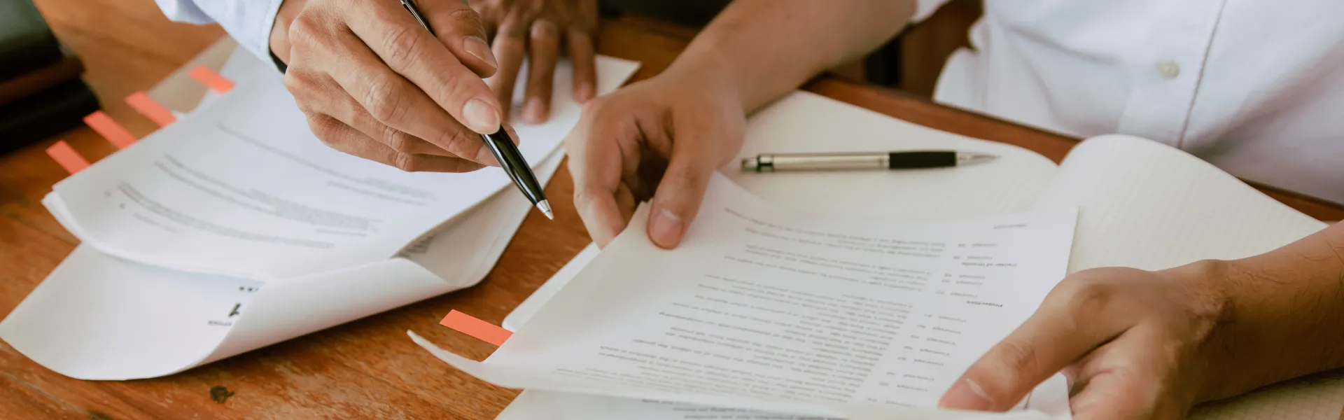 Dealership employee showing customers cars on showroom floor.